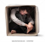 stock-photo-man-crouched-in-a-box-115103512.jpg